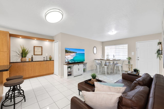 7853 W 36th Ave Unit 104, Hialeah, FL 33018 - living room with a textured ceiling and light tile patterned floors