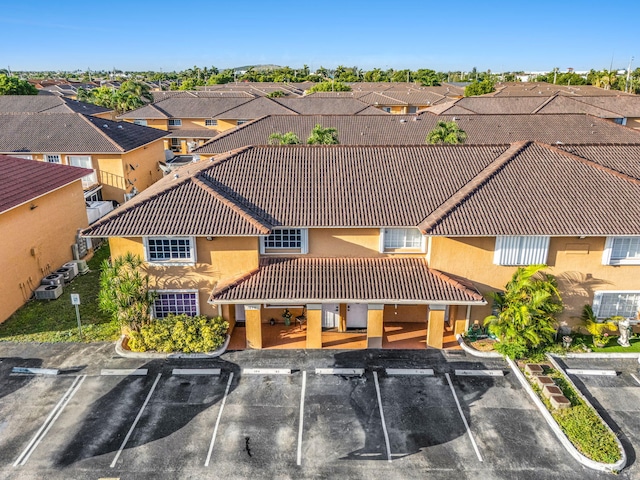 7853 W 36th Ave Unit 104, Hialeah, FL 33018 - view of building exterior with uncovered parking and a residential view