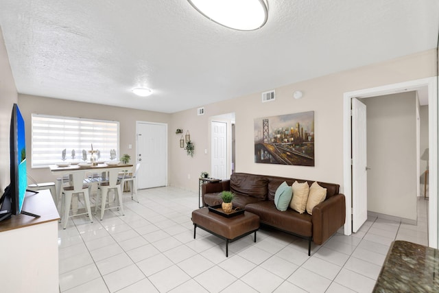 7853 W 36th Ave Unit 104, Hialeah, FL 33018 - living room with a textured ceiling and light tile patterned flooring