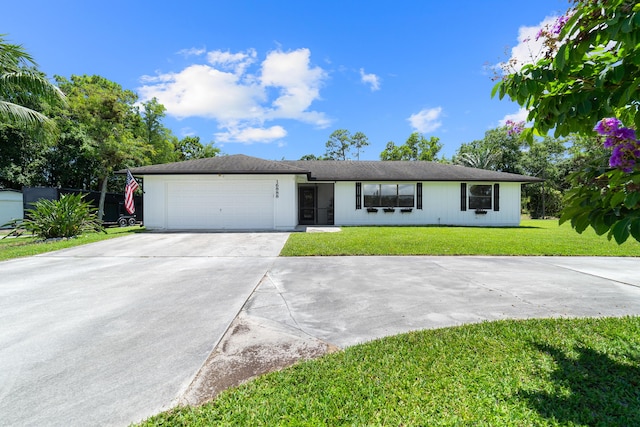 16888 W Stallion Dr, Loxahatchee, FL 33470 - single story home with driveway, an attached garage, and a front lawn