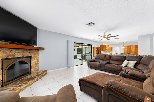 16888 W Stallion Dr, Loxahatchee, FL 33470 - living room featuring a ceiling fan, light tile patterned flooring, and a stone fireplace
