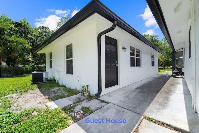 16888 W Stallion Dr, Loxahatchee, FL 33470 - view of side of property featuring stucco siding and a patio area