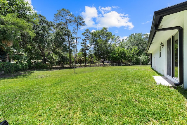 16888 W Stallion Dr, Loxahatchee, FL 33470 - view of green lawn with view of wooded area