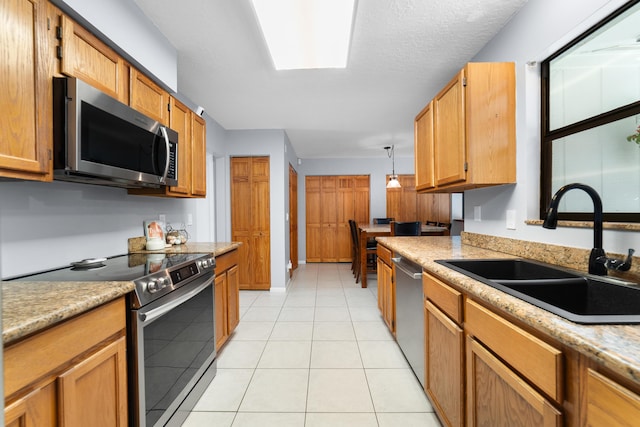 16888 W Stallion Dr, Loxahatchee, FL 33470 - kitchen with stainless steel appliances, light countertops, light tile patterned floors, and brown cabinets