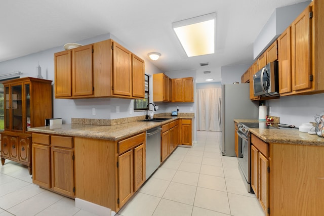 16888 W Stallion Dr, Loxahatchee, FL 33470 - kitchen featuring appliances with stainless steel finishes, light tile patterned floors, and brown cabinets