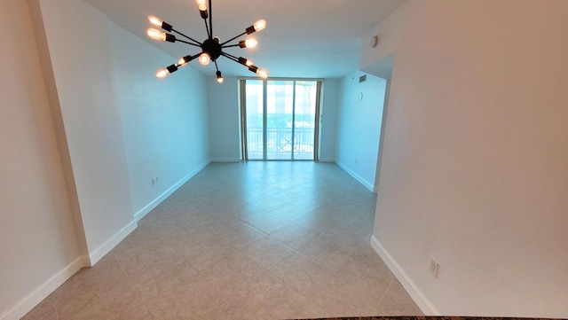 450 N Federal Hwy Unit 1101, Boynton Beach, FL 33435 - empty room featuring a chandelier, light tile patterned floors, and expansive windows