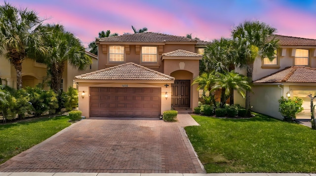 9196 Dupont Pl, Wellington, FL 33414 - mediterranean / spanish-style home featuring stucco siding, a garage, a tiled roof, and decorative driveway