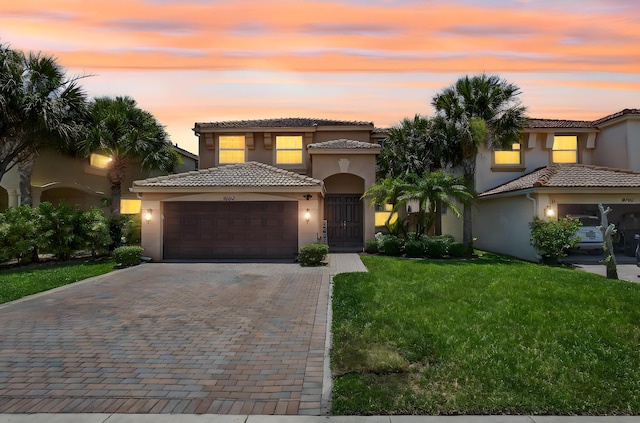 9196 Dupont Pl, Wellington, FL 33414 - mediterranean / spanish-style home with an attached garage, stucco siding, and decorative driveway