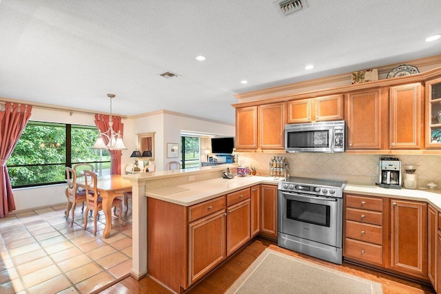 3843 Quail Ridge Drive Mallard, Boynton Beach, FL 33436 - kitchen featuring appliances with stainless steel finishes, a peninsula, tasteful backsplash, healthy amount of natural light, and recessed lighting