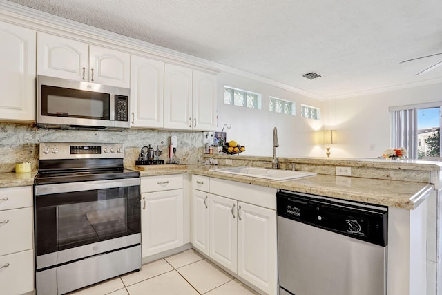 3385 Seabreeze Ln, Margate, FL 33063 - kitchen featuring stainless steel appliances, a peninsula, ornamental molding, light tile patterned floors, and backsplash
