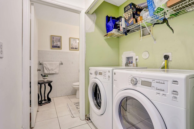3385 Seabreeze Ln, Margate, FL 33063 - washroom with washer and clothes dryer, tile walls, light tile patterned floors, and wainscoting