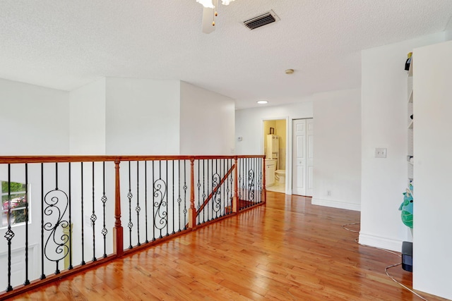 3385 Seabreeze Ln, Margate, FL 33063 - corridor with wood finished floors, a textured ceiling, recessed lighting, and an upstairs landing