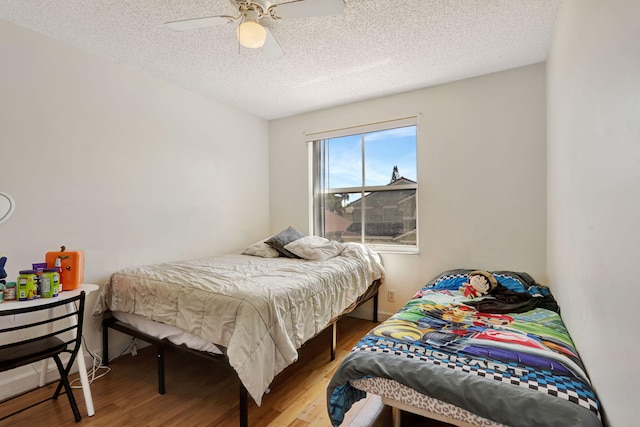 3385 Seabreeze Ln, Margate, FL 33063 - bedroom with wood finished floors, a textured ceiling, and ceiling fan