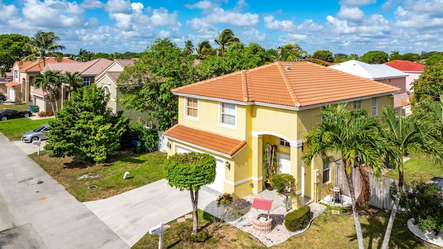 3385 Seabreeze Ln, Margate, FL 33063 - mediterranean / spanish house featuring a tile roof, a garage, stucco siding, and concrete driveway