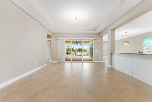 2854 Bellarosa Cir, Royal Palm Beach, FL 33411 - empty room featuring ceiling fan, a tray ceiling, and light tile patterned floors