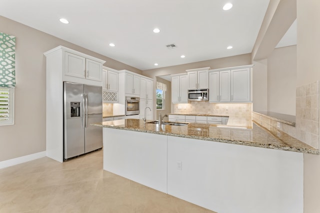 2854 Bellarosa Cir, Royal Palm Beach, FL 33411 - kitchen with appliances with stainless steel finishes, a peninsula, light stone countertops, white cabinets, and recessed lighting