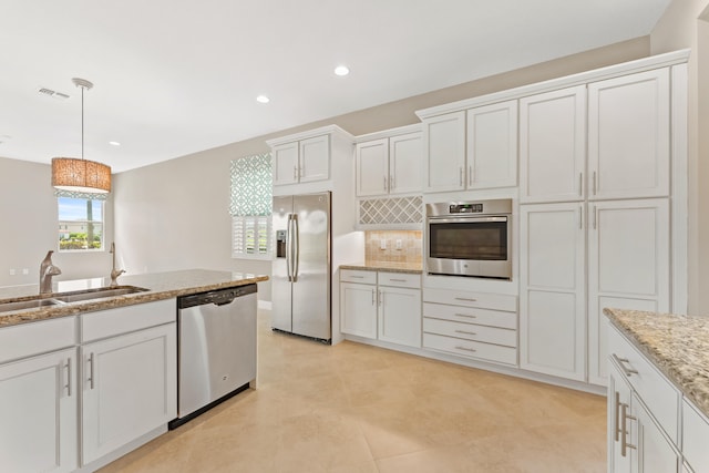 2854 Bellarosa Cir, Royal Palm Beach, FL 33411 - kitchen featuring appliances with stainless steel finishes, pendant lighting, white cabinetry, tasteful backsplash, and recessed lighting