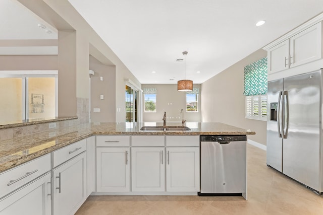 2854 Bellarosa Cir, Royal Palm Beach, FL 33411 - kitchen with appliances with stainless steel finishes, a peninsula, white cabinetry, light stone countertops, and light tile patterned floors