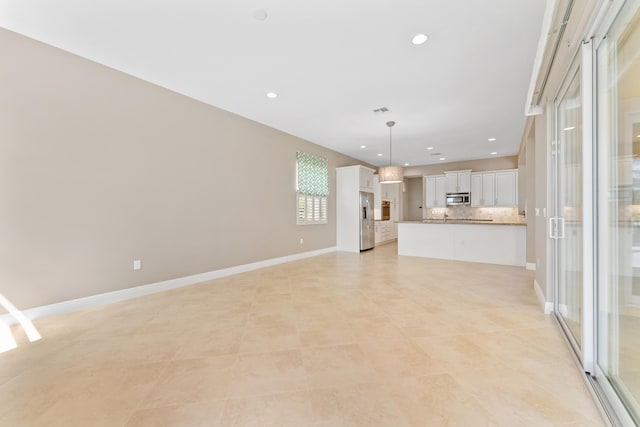 2854 Bellarosa Cir, Royal Palm Beach, FL 33411 - unfurnished living room with recessed lighting, plenty of natural light, and light tile patterned flooring