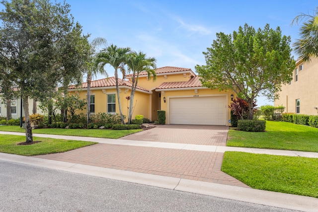 2854 Bellarosa Cir, Royal Palm Beach, FL 33411 - mediterranean / spanish-style house featuring decorative driveway, stucco siding, a garage, a tile roof, and a front lawn