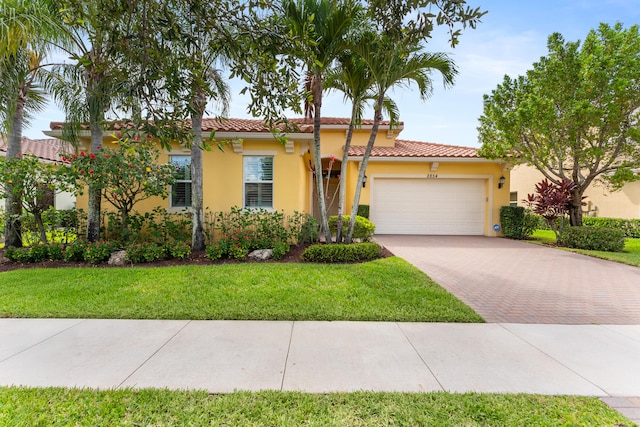 2854 Bellarosa Cir, Royal Palm Beach, FL 33411 - mediterranean / spanish-style home with decorative driveway, a garage, stucco siding, a front lawn, and a tile roof