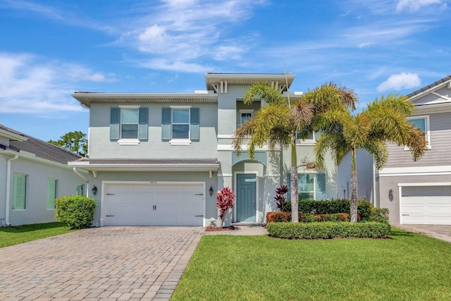 4610 SW Ardsley Dr, Stuart, FL 34997 - view of front facade featuring stucco siding, driveway, a front lawn, and an attached garage