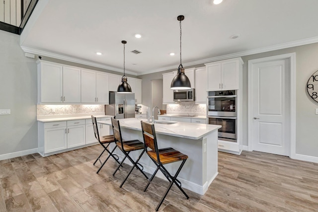 4610 SW Ardsley Dr, Stuart, FL 34997 - kitchen featuring appliances with stainless steel finishes, decorative backsplash, light countertops, a breakfast bar area, and crown molding