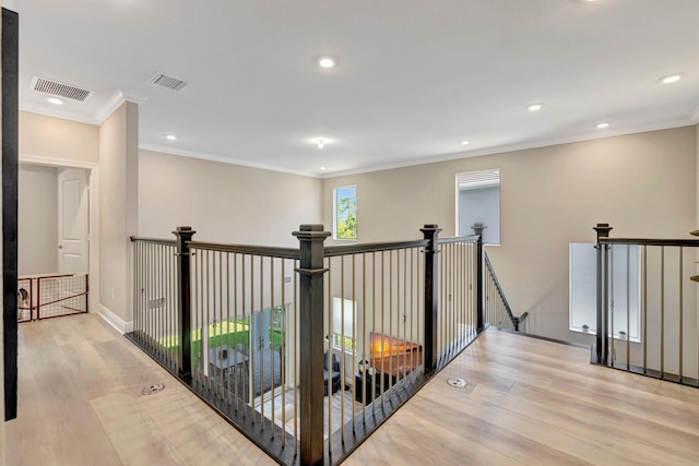 4610 SW Ardsley Dr, Stuart, FL 34997 - hall with an upstairs landing, wood finished floors, recessed lighting, and crown molding
