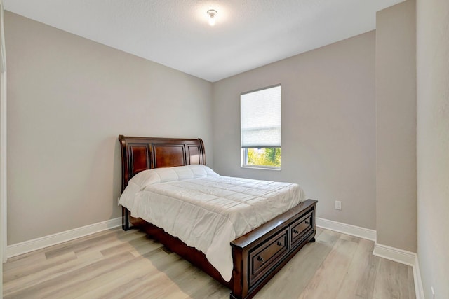 4610 SW Ardsley Dr, Stuart, FL 34997 - bedroom featuring light wood-style floors and baseboards