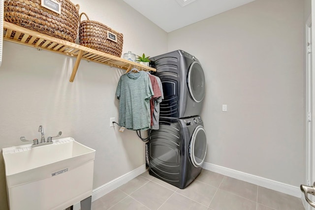 4610 SW Ardsley Dr, Stuart, FL 34997 - laundry room featuring stacked washing machine and dryer and light tile patterned floors