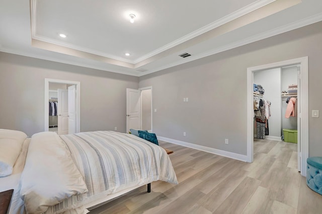 4610 SW Ardsley Dr, Stuart, FL 34997 - bedroom featuring a walk in closet, a closet, crown molding, a tray ceiling, and recessed lighting