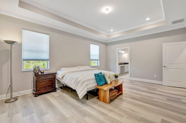 4610 SW Ardsley Dr, Stuart, FL 34997 - bedroom featuring light wood finished floors, a raised ceiling, ornamental molding, recessed lighting, and ensuite bath