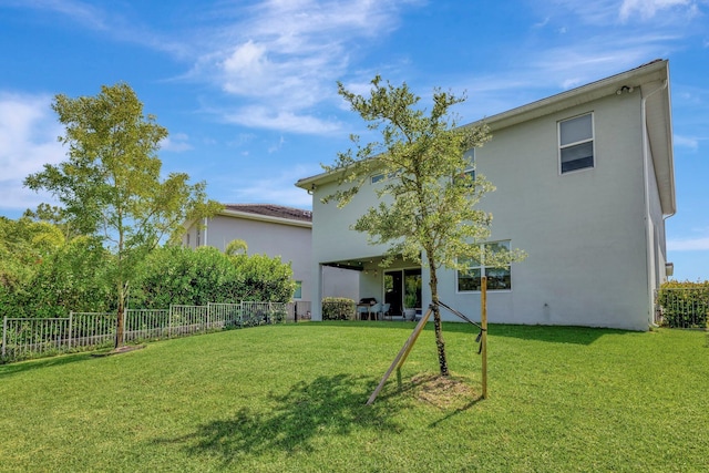 4610 SW Ardsley Dr, Stuart, FL 34997 - back of house with stucco siding and a fenced backyard