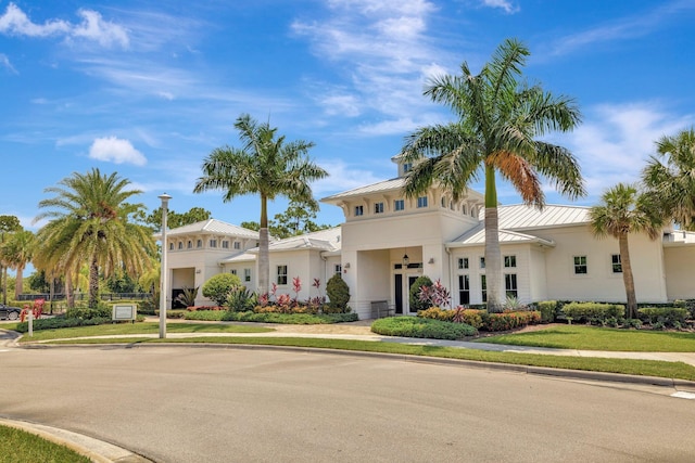 4610 SW Ardsley Dr, Stuart, FL 34997 - mediterranean / spanish house with stucco siding, a standing seam roof, a metal roof, and a garage