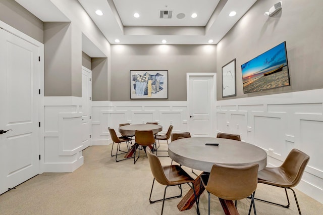 4610 SW Ardsley Dr, Stuart, FL 34997 - dining space with a decorative wall, light colored carpet, recessed lighting, wainscoting, and a raised ceiling