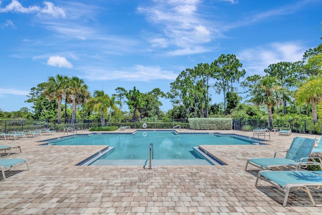 4610 SW Ardsley Dr, Stuart, FL 34997 - community pool with a patio and view of scattered trees