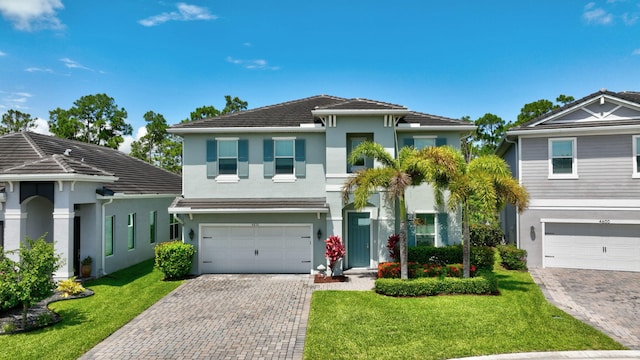 4610 SW Ardsley Dr, Stuart, FL 34997 - view of front facade featuring stucco siding, an attached garage, decorative driveway, and a front lawn