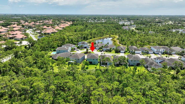 4610 SW Ardsley Dr, Stuart, FL 34997 - aerial perspective of suburban area with a nearby body of water and a forest