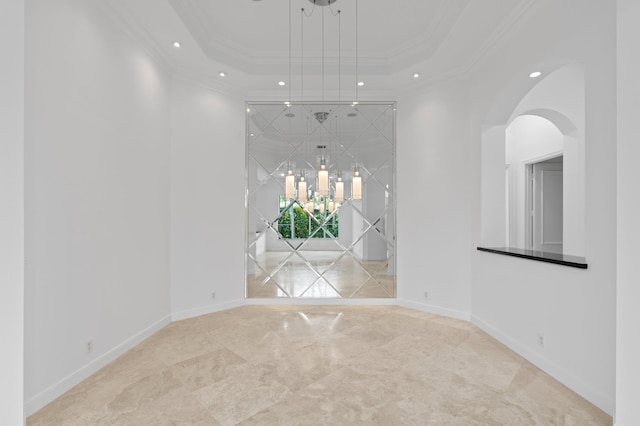 16284 Via Venetia W, Delray Beach, FL 33484 - empty room featuring a raised ceiling, arched walkways, recessed lighting, marble tiled floors, and a chandelier