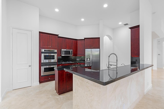 16284 Via Venetia W, Delray Beach, FL 33484 - kitchen featuring appliances with stainless steel finishes, dark brown cabinets, dark countertops, a peninsula, and recessed lighting