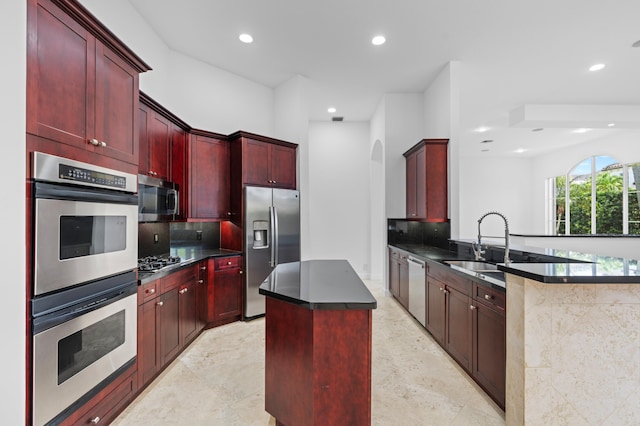 16284 Via Venetia W, Delray Beach, FL 33484 - kitchen featuring dark brown cabinets, stainless steel appliances, dark countertops, recessed lighting, and a center island