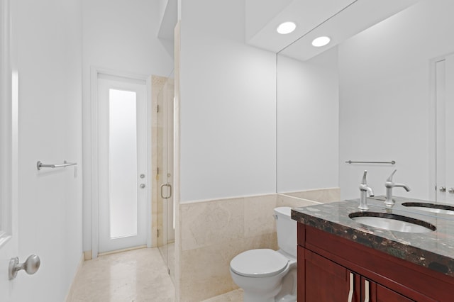 16284 Via Venetia W, Delray Beach, FL 33484 - bathroom featuring vanity, a stall shower, recessed lighting, tile walls, and a wainscoted wall