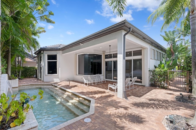 16284 Via Venetia W, Delray Beach, FL 33484 - back of property with a patio, an outdoor pool, and stucco siding