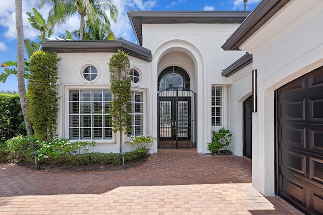 16284 Via Venetia W, Delray Beach, FL 33484 - entrance to property featuring french doors, stucco siding, and decorative driveway