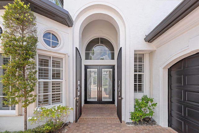 16284 Via Venetia W, Delray Beach, FL 33484 - doorway to property featuring french doors, stucco siding, and a garage