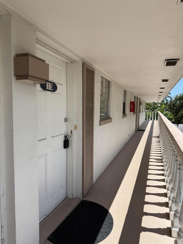 148 Yacht Club Dr Unit 13, North Palm Beach, FL 33408 - property entrance featuring stucco siding and a balcony