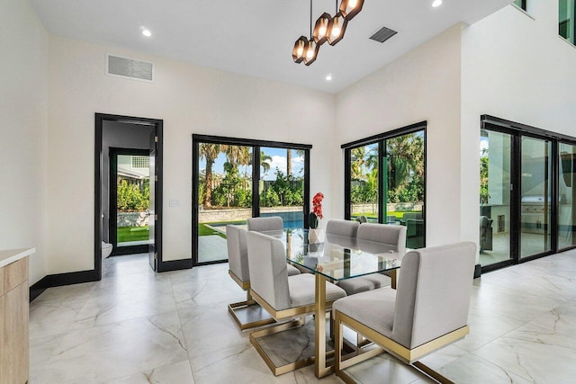 13480 US Highway 1, Juno Beach, FL 33408 - dining space with light marble finish floors, a chandelier, recessed lighting, and a towering ceiling