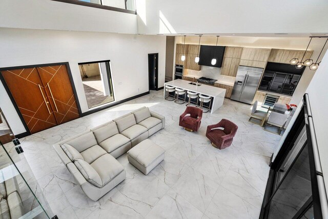13480 US Highway 1, Juno Beach, FL 33408 - living room featuring light marble finish flooring and a high ceiling