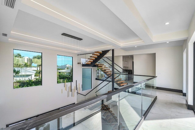 13480 US Highway 1, Juno Beach, FL 33408 - stairway with recessed lighting, marble finish floors, and a tray ceiling
