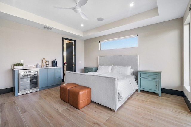 13480 US Highway 1, Juno Beach, FL 33408 - bedroom featuring beverage cooler, light wood finished floors, recessed lighting, a raised ceiling, and a ceiling fan
